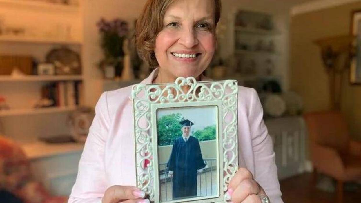 Judi Reiss holds a photograph of her son Joshua on the 20th anniversary of his death.
