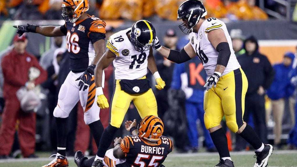 JuJu Smith-Schuster #19 of the Pittsburgh Steelers stands over Vontaze Burfict