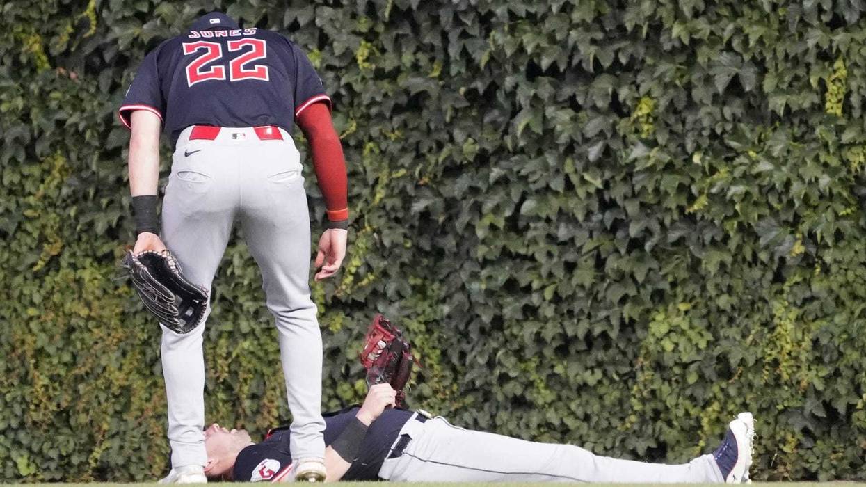 Jul 1, 2025; Chicago, Illinois, USA; Cleveland Guardians outfielder Lane Thomas (8) catches a ball hit by Chicago Cubs third base Matt Shaw (not pictured as outfielder Nolan Jones (22) stands nearby during the fifth inning at Wrigley Field.