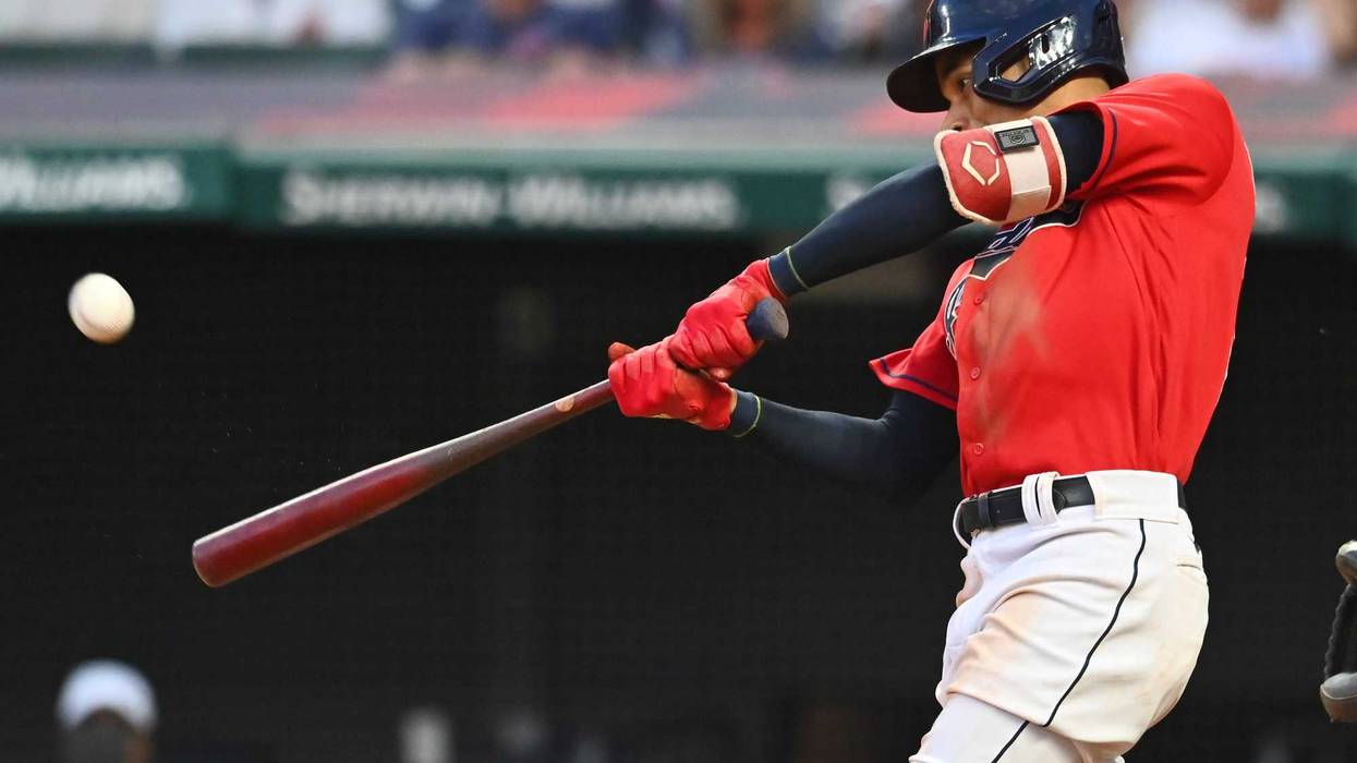 Jul 10, 2021; Cleveland, Ohio, USA; Cleveland Indians left fielder Oscar Mercado (35) hits a home run against the Kansas City Royals during the seventh inning at Progressive Field.