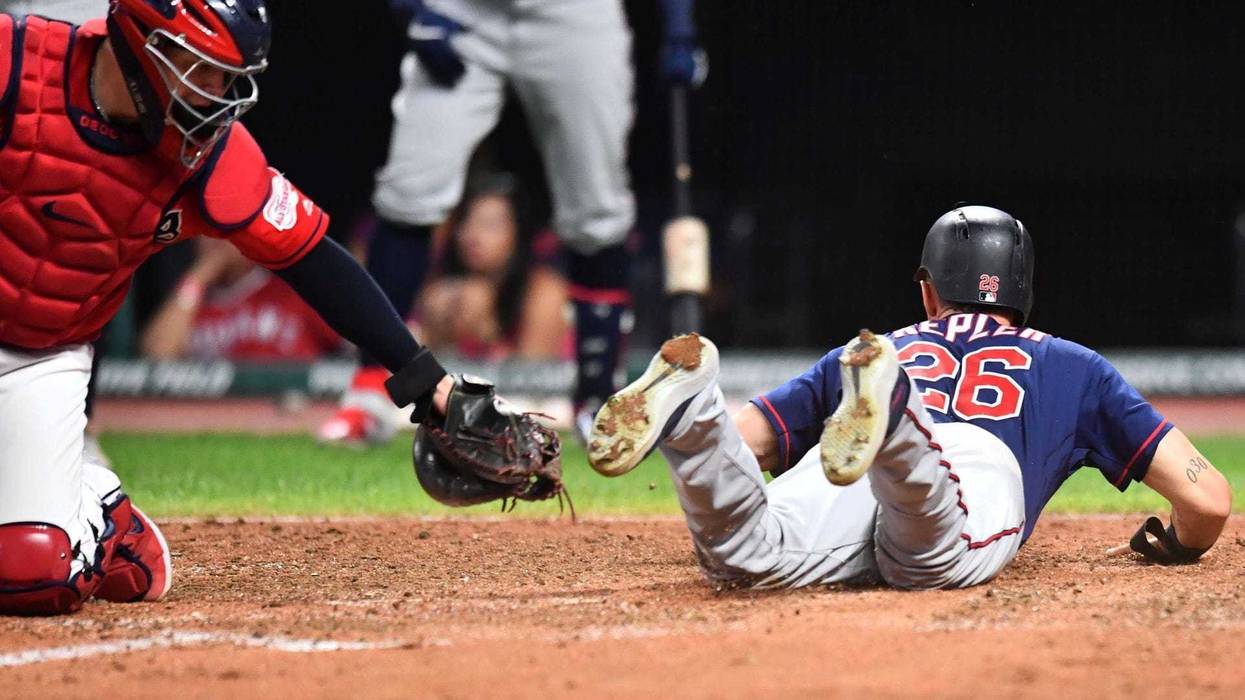 Jul 12, 2019; Cleveland, OH, USA; Minnesota Twins right fielder Max Kepler (26) slides into home as Cleveland Indians catcher Roberto Perez (55) is late with the tag during the seventh inning at Progressive Field. Mandatory Credit: Ken Blaze-USA TODAY Spo