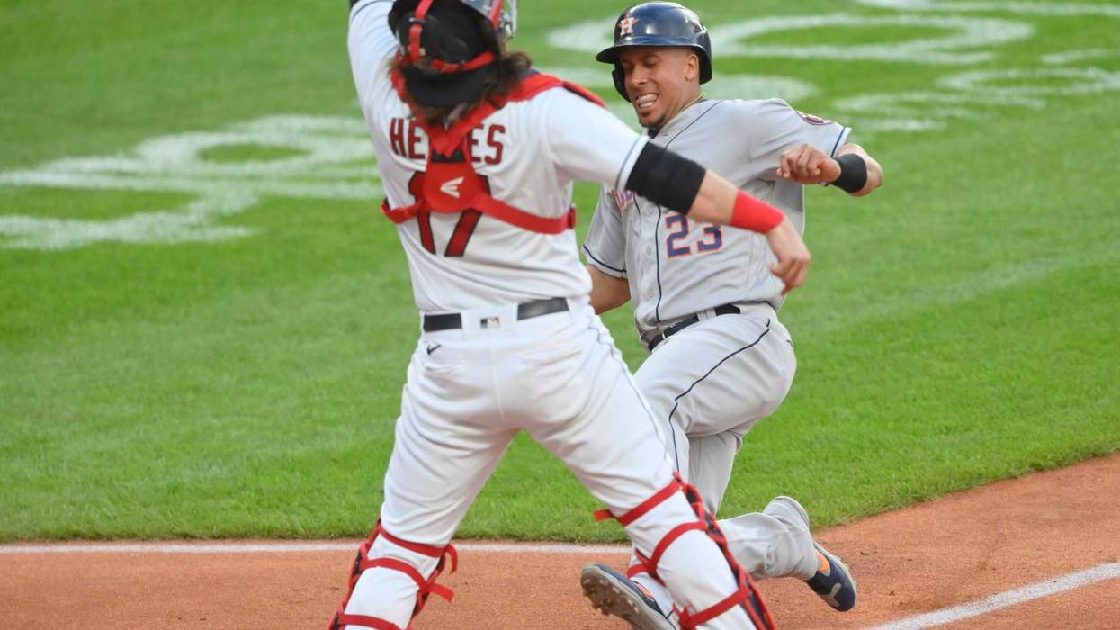 Jul 2, 2021; Cleveland, Ohio, USA; Houston Astros designated hitter Michael Brantley (23) scores against Cleveland Indians catcher Austin Hedges (17) in the third inning at Progressive Field.