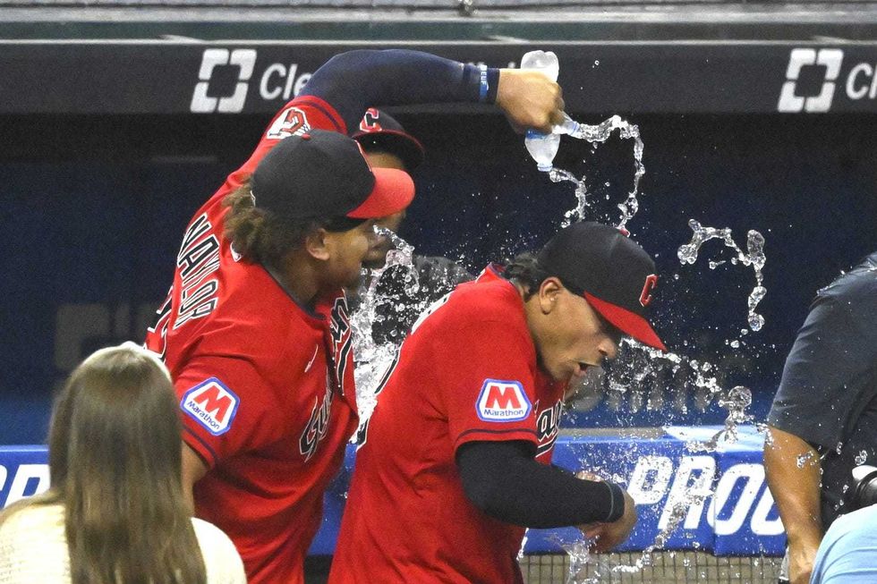 Jul 25, 2023; Cleveland, Ohio, USA; Cleveland Guardians first baseman Josh Naylor (22) pours water on his brother catcher Bo Naylor (23) after a win over the Kansas City Royals at Progressive Field.