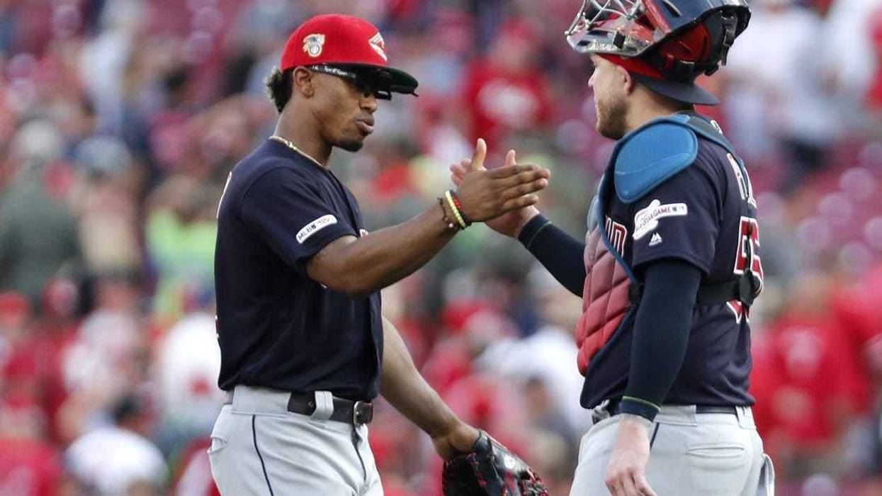 Jul 6, 2019; Cincinnati, OH, USA; Cleveland Indians shortstop Francisco Lindor (left) and catcher Roberto Perez (55) react after the Indians defeated the Cincinnati Reds at Great American Ball Park. Mandatory Credit: David Kohl-USA TODAY Sports