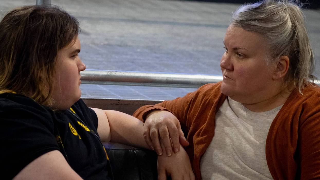 Julia Kathary (right) listens to her daughter, Connie Kathary (left), talk about her day at school at a marketplace in Indianapolis, Indiana, earlier this year.