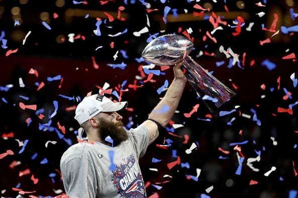 Julian Edelman hoists the Lombardi Trophy