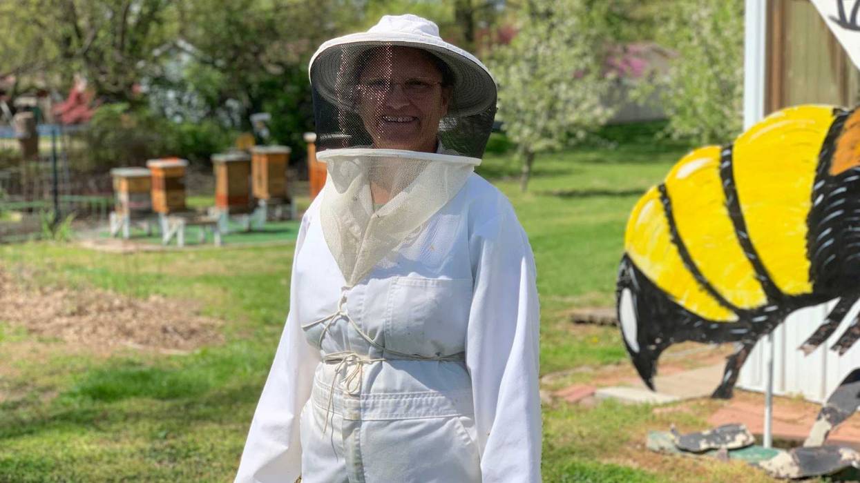 Julie McKinney prepares to inspect her hives