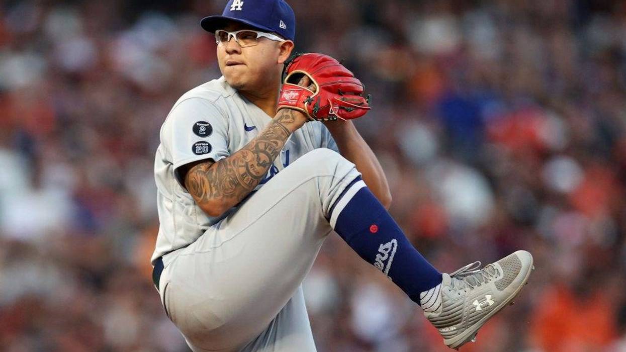 Julio Urias #7 of the Los Angeles Dodgers pitches in the first inning against the San Francisco Giants during Game 2 of the National League Division Series at Oracle Park.