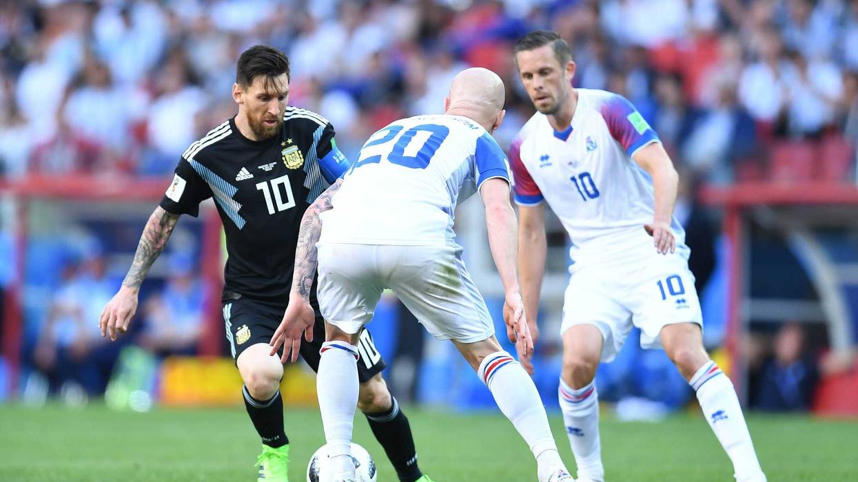 Jun 16, 2018; Moscow, Russia; Argentina forward Lionel Messi (10) controls the ball against Iceland midfielder Gylfi Sigurdsson (10) and midfielder Emil Hallfredsson (20) in Group D play during the FIFA World Cup 2018 at Spartak Stadium.