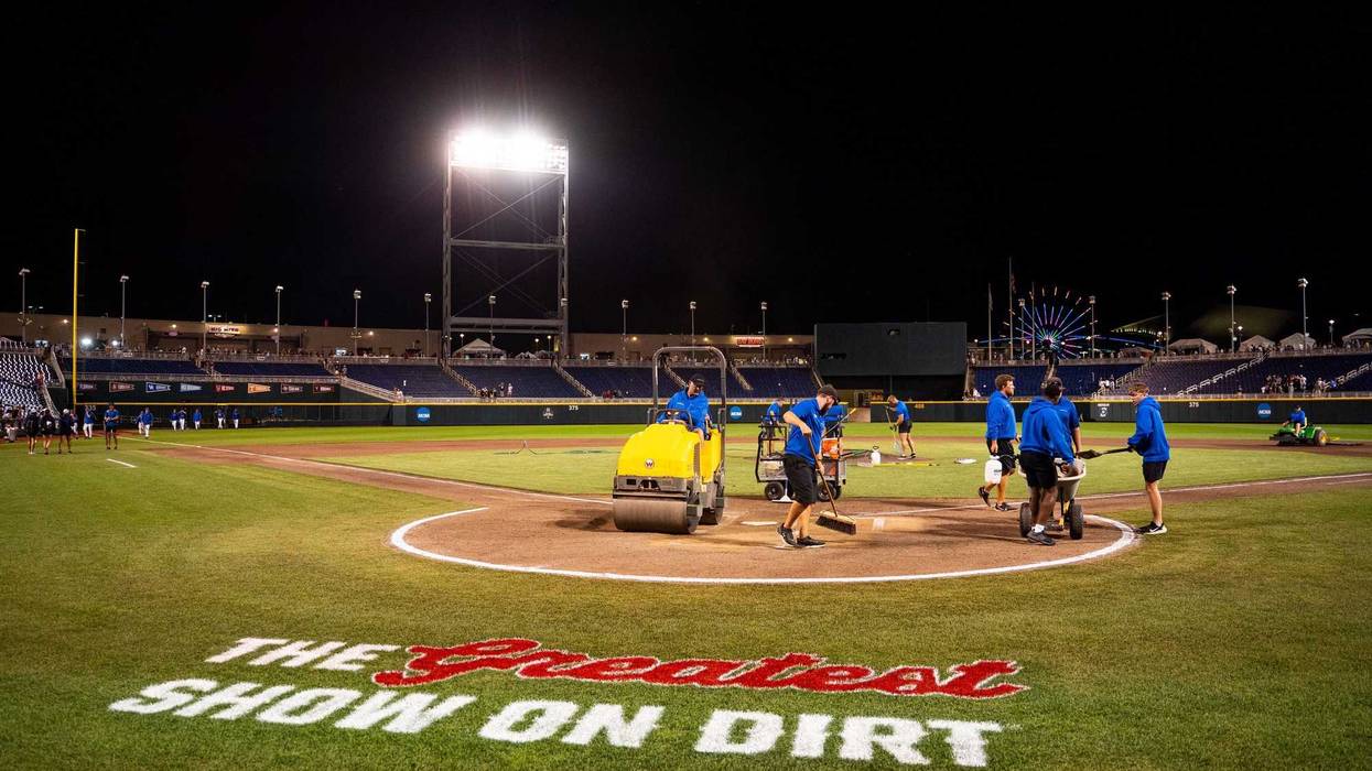 Jun 19, 2024; Omaha, NE, USA; Grounds crew work on the field after the game between the Texas A&M Aggies and the Florida Gators at Charles Schwab Field Omaha. Mandatory Credit: Dylan Widger-USA TODAY Sports