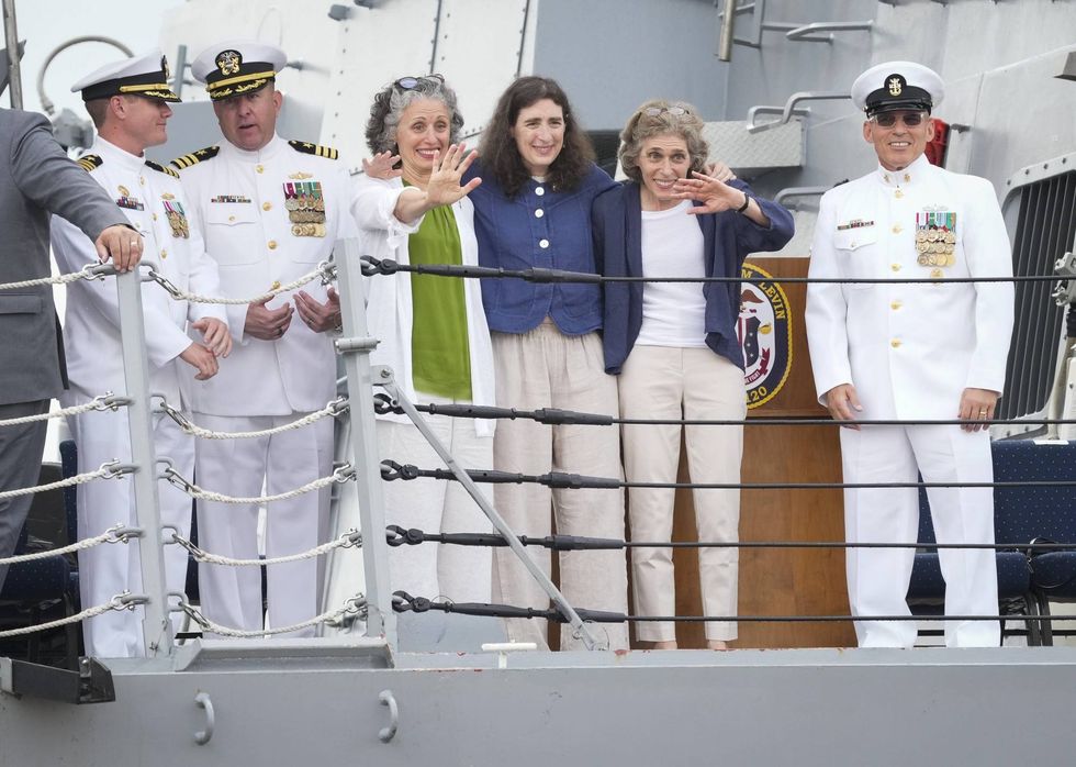 Jun 24, 2023; Baltimore, MD, USA; Kate Levin Markel, center left, Laura Levin, center right, and Erica Levin, center, wave to the crowd gathered during the commissioning ceremony for the USS Carl M. Levin (DDG 120) in Baltimore, MD alongside USS Carl M. Levin Commander Kelly Craft, left, Executive Officer Commander Jason Holbrook, second from left, and Command Master Chief Mark W. Melia, right, on Saturday, June 24, 2023. The USS Carl M. Levin is a United States Navy Arleigh Burke-class Flight IIA guided missile destroyer, the 70th overall for the class. The ship s namesake served in the U.S. Senate for 36 years from 1979-2015. As the longest serving senator in Michigan state history, Levin became a staunch supporter of the armed services through his work and leadership as Chairman and Ranking Member of the Senate Committee on Armed Services. Levin passed away on July 29, 2021