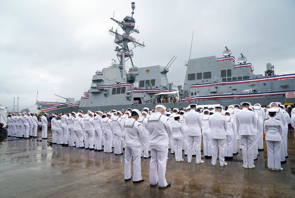 Jun 24, 2023; Baltimore, MD, USA; The crew of the USS Carl M. Levin (DDG 120) during a moment in prayer during the commissioning ceremony for the USS Carl M. Levin (DDG 120) in Baltimore, MD on Saturday, June 24, 2023