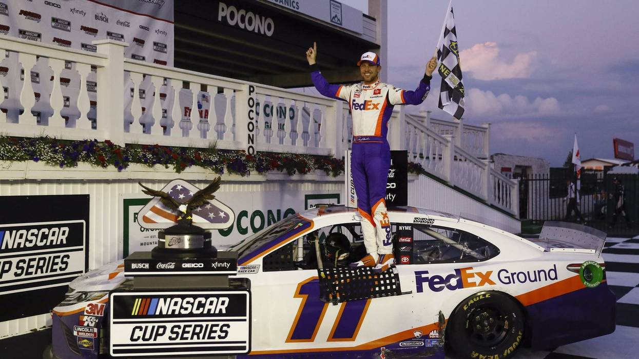 Jun 28, 2020; Long Pond, Pennsylvania, USA; Denny Hamlin celebrates in victory lane after winning the Pocono 350 Cup Series at Pocono Raceway.