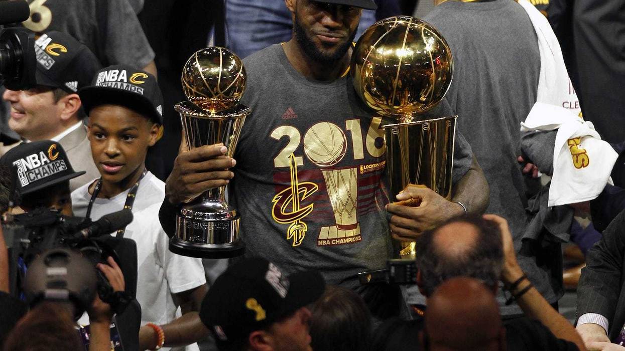 June 19, 2016; Oakland, CA, USA; Cleveland Cavaliers forward LeBron James (23) celebrates with the Larry O'Brien championship and Bill Russell MVP trophies following the 93-89 victory against the Golden State Warriors in game seven of the NBA Finals at Oracle Arena.