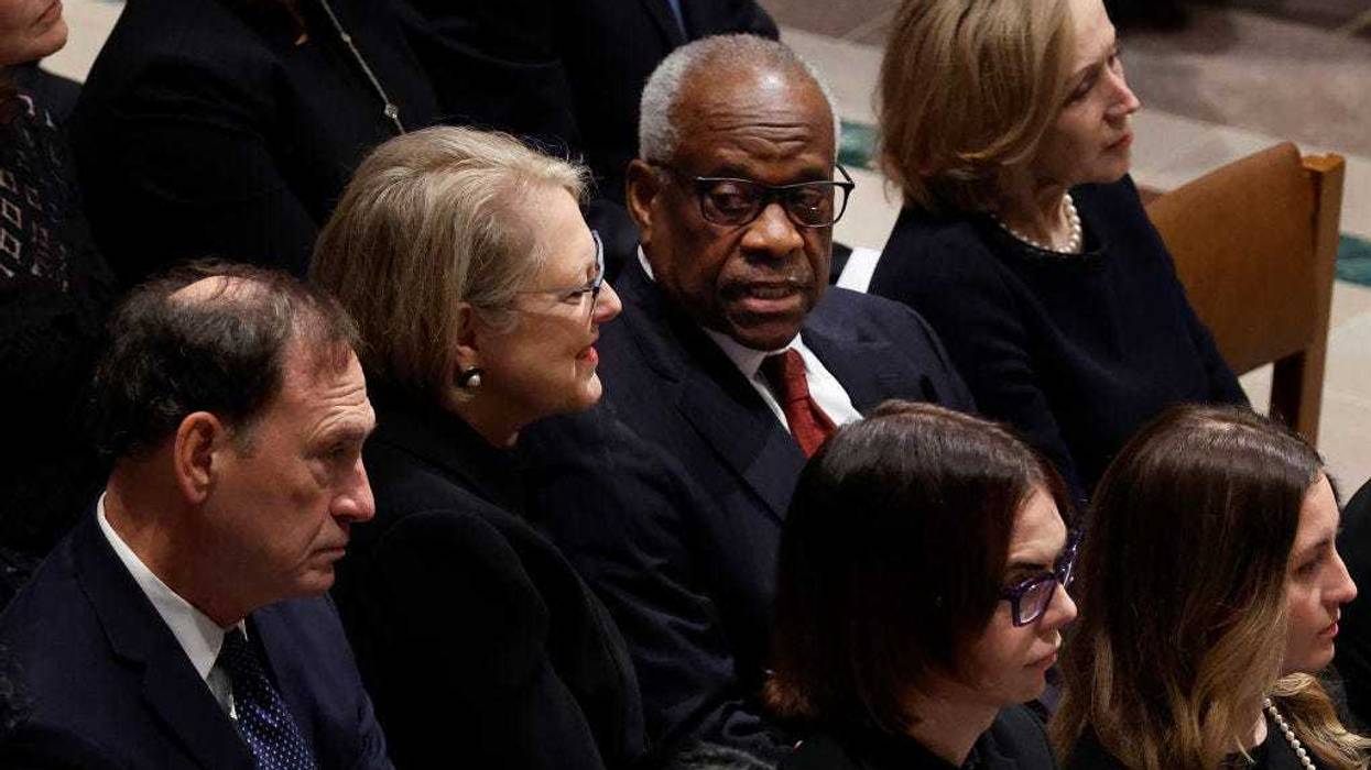 Justice Clarence Thomas (2nd R) talks with his wife Virginia Thomas as they and Justice Samuel Alito, Jr. (L) attend the funeral service for late retired Supreme Court Justice Sandra Day O'Connor at Washington National Cathedral on December 19, 2023 in Washington, DC.