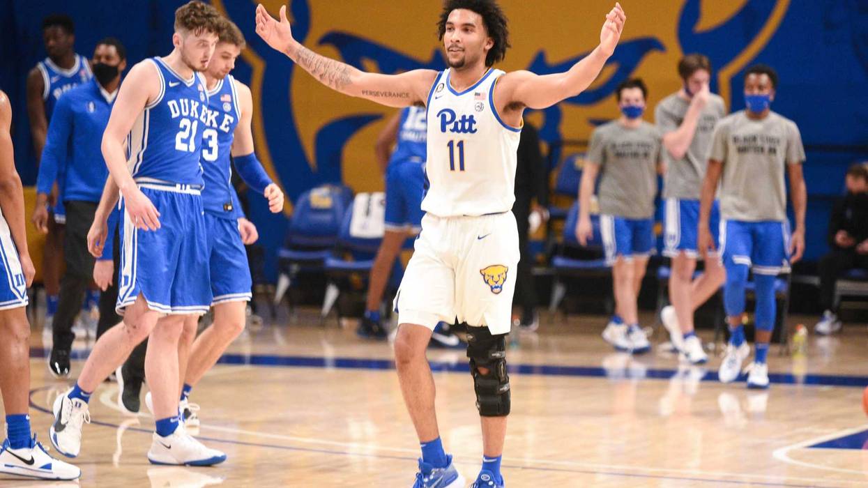 Justin Champagnie with arms up