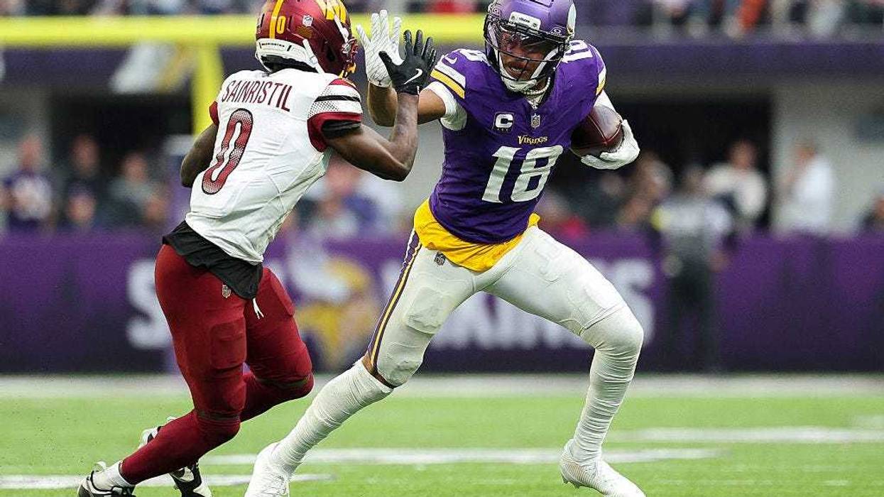 Justin Jefferson #18 of the Minnesota Vikings runs with the ball against Mike Sainristil #0 of the Washington Commanders during the third quarter at U.S. Bank Stadium on December 07, 2025 in Minneapolis, Minnesota.