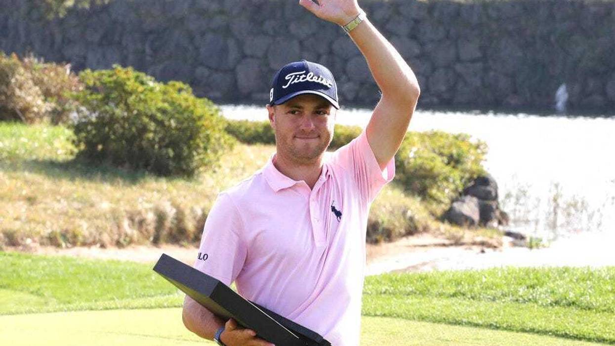 Justin Thomas of the United States waves with his trophy after winning the CJ Cup PGA golf tournament at Nine Bridges on Jeju Island, South Korea, Sunday, Oct. 20, 2019.