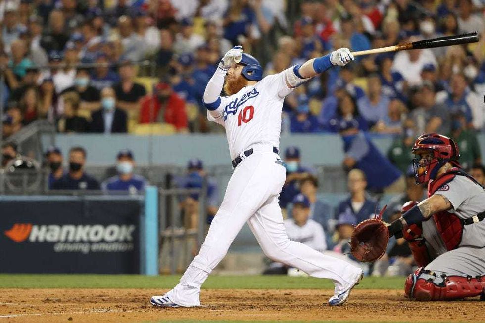 Justin Turner #10 of the Los Angeles Dodgers hits a solo home run in the fourth inning.