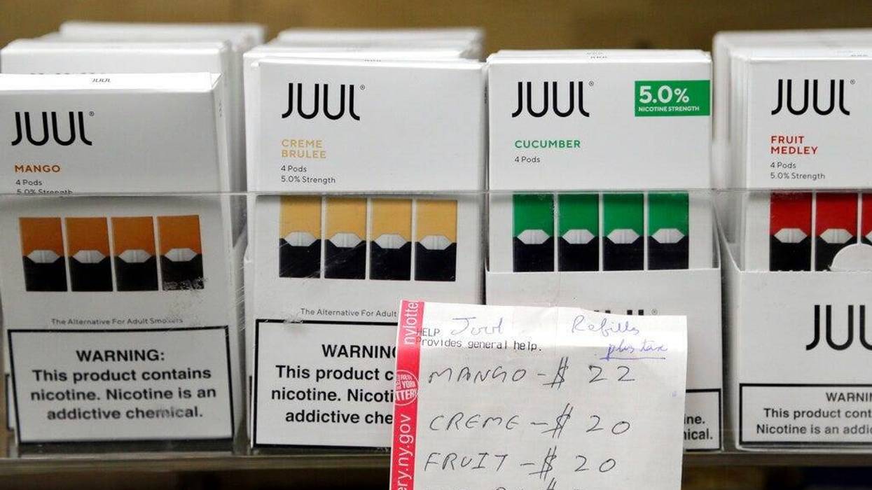 Juul products are displayed at a smoke shop in New York. On Thursday, Oct. 17, 2019, the company announced it will voluntarily stop selling its fruit and dessert-flavored vaping pods.