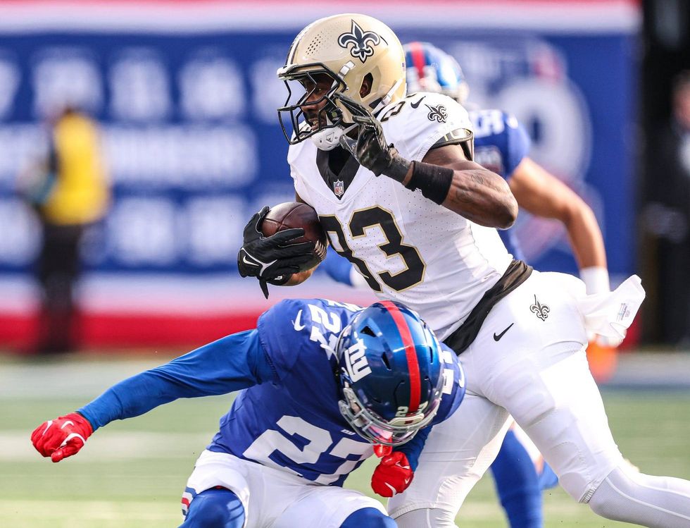 Juwan Johnson makes a catch during a 2024 win against the New York Giants