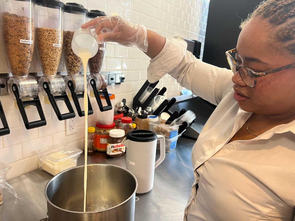 Kamillah Lucas prepares ice cream at Nitro Nostalgia in Bronzeville. At the shop, Lucas and her father Garland Lucas use liquid nitrogen to create frozen concoctions.
