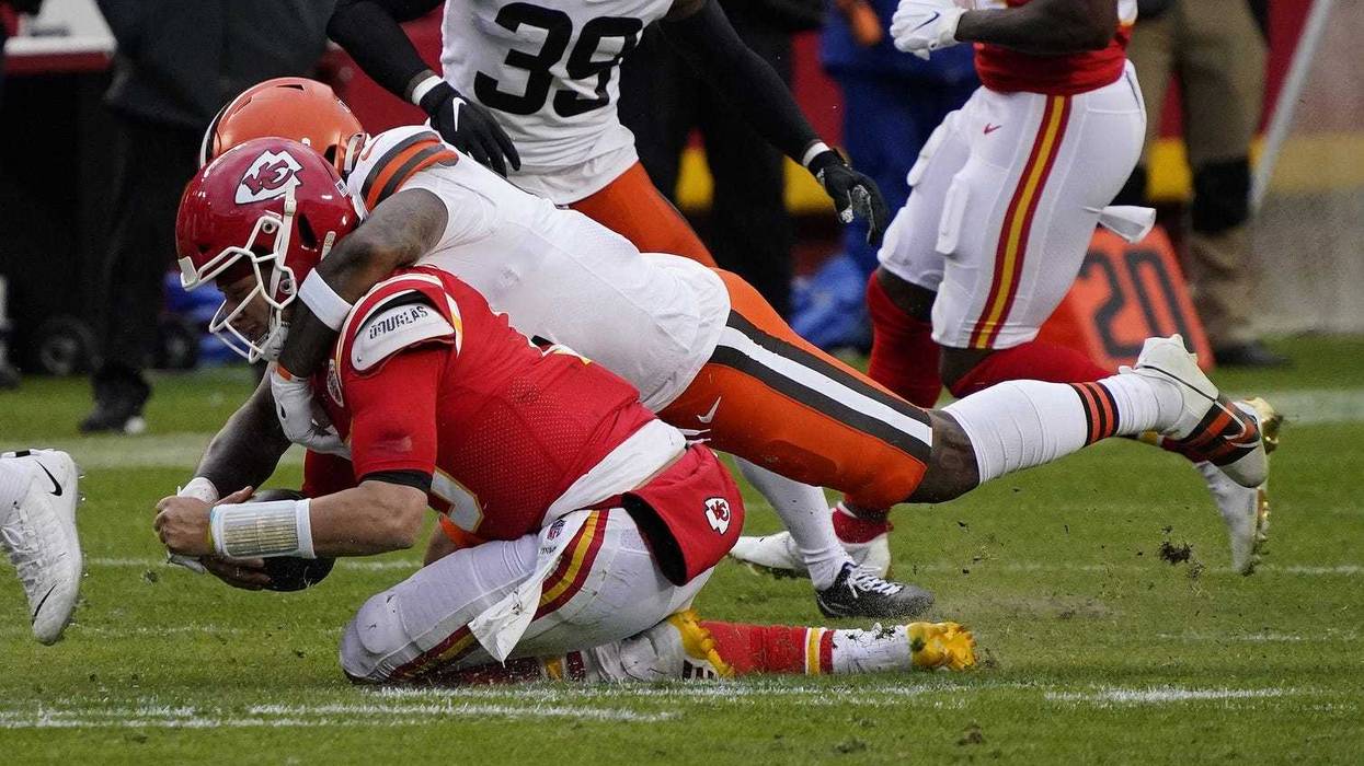 Kansas City Chiefs quarterback Patrick Mahomes (15) is brought down by Cleveland Browns outside linebacker Mack Wilson (51) during the second half in the AFC Divisional Round playoff game at Arrowhead Stadium. Mahomes would suffer an injury on the play.