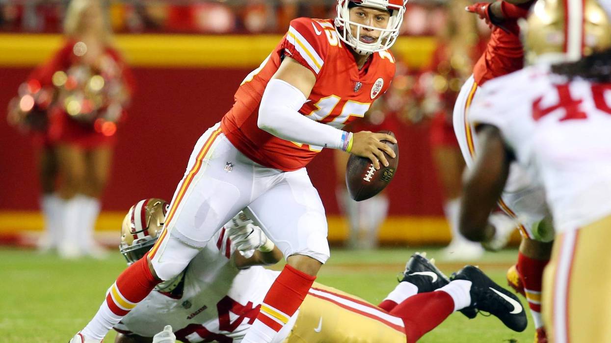 Kansas City Chiefs quarterback Patrick Mahomes II (15) evades San Francisco 49ers defensive lineman Solomon Thomas (94) in the second half at Arrowhead Stadium.