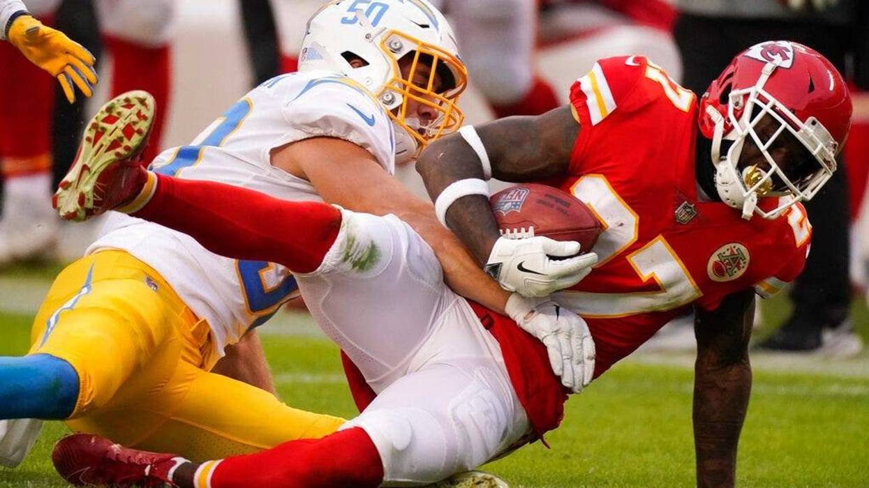 Kansas City Chiefs' Rashad Fenton is tackled by Los Angeles Chargers linebacker Cole Christiansen, left, during the first half of an NFL football game, Sunday, Jan. 3, 2021, in Kansas City.