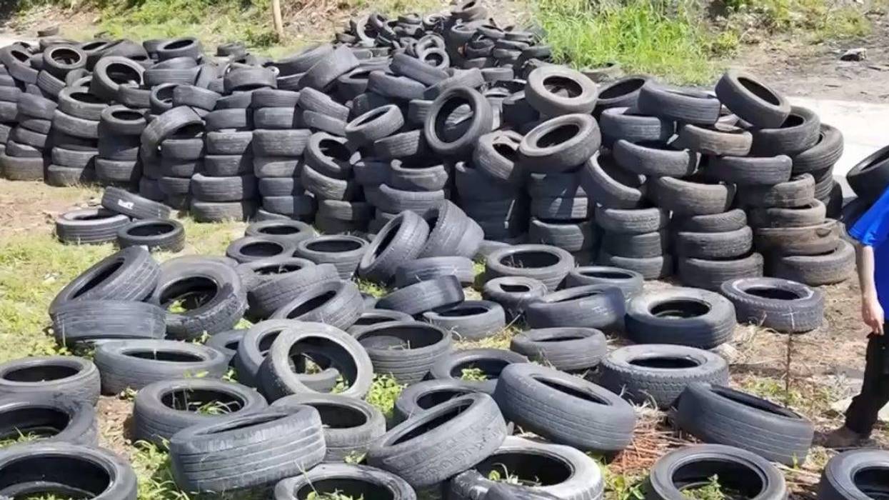 Kansas City illegal dumping investigator walks through a lot containing thousands of tires
