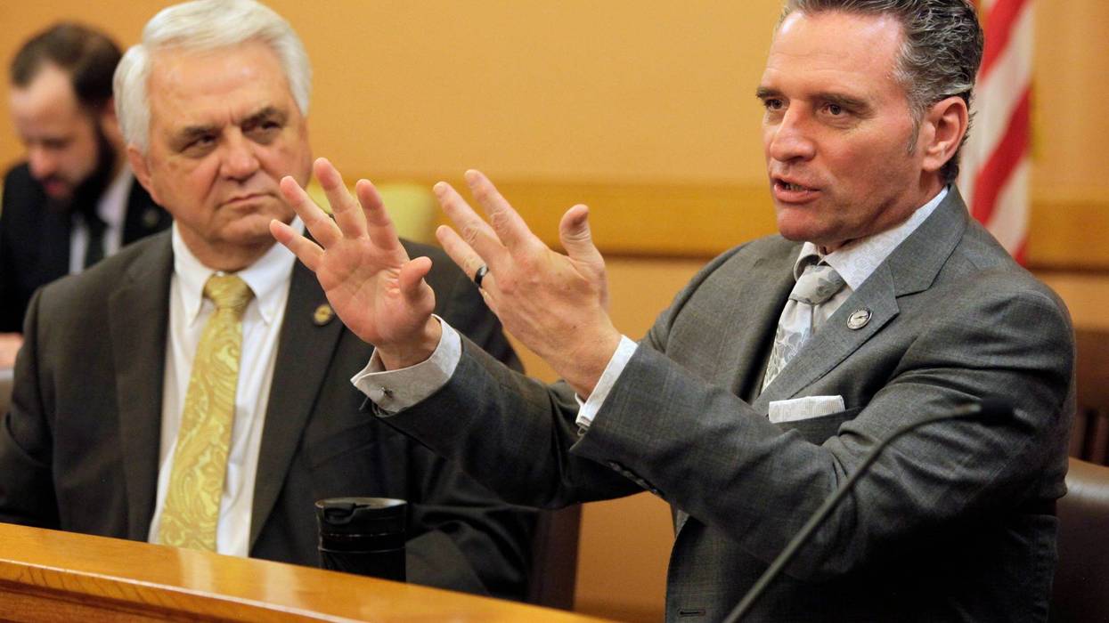 Kansas Senate President Ty Masterson, right, R-Andover, briefly discusses tax issues with fellow Republican senators as Majority Leader Larry Alley, left, R-Winfield, watches