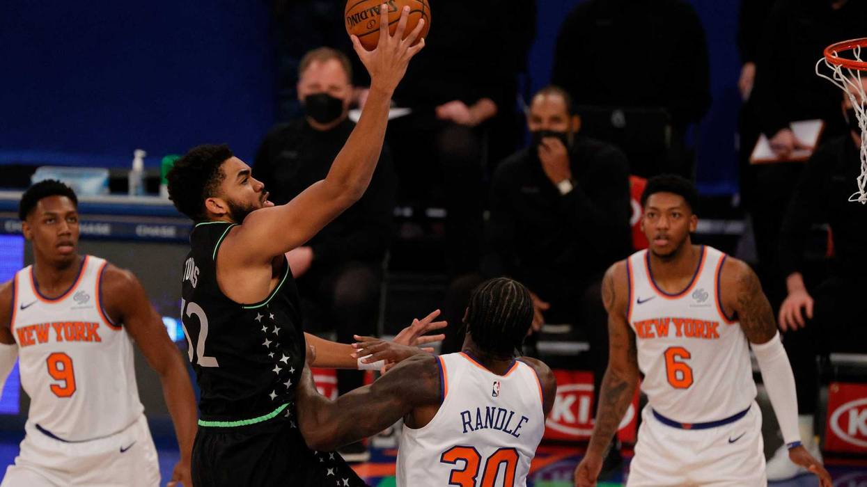 Karl-Anthony Towns #32 of the Minnesota Timberwolves shoots Julius Randle #30 of the New York Knicks defends during the first half at Madison Square Garden on February 21, 2021 in New York City.