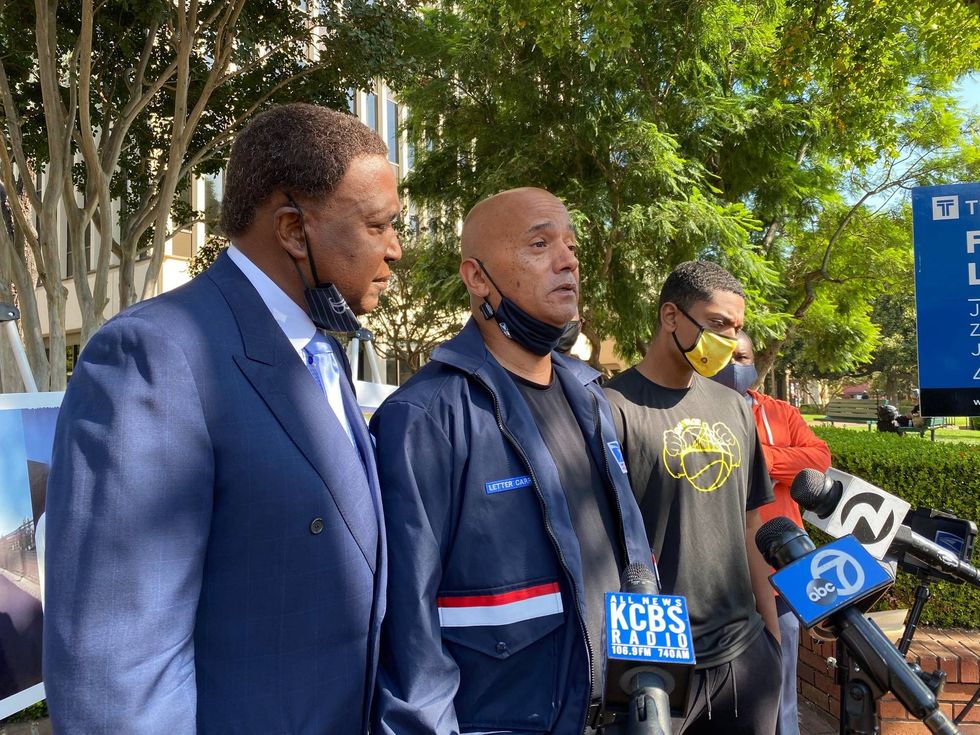 Karl Bracy and his attorney, John Burris, speak to the media Thursday.