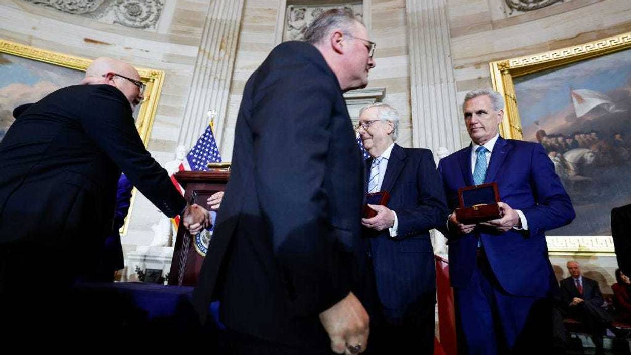 Kenneth and Craig Sicknick, the brothers of Capitol Police officer Brian Sicknick who died after the events of January 6, walk past Senate Minority Leader Mitch McConnell (R-KY) and House Minority Leader Kevin McCarthy (R-CA) during a Congressional Gold Medal Ceremony for U.S. Capitol Police and D.C.