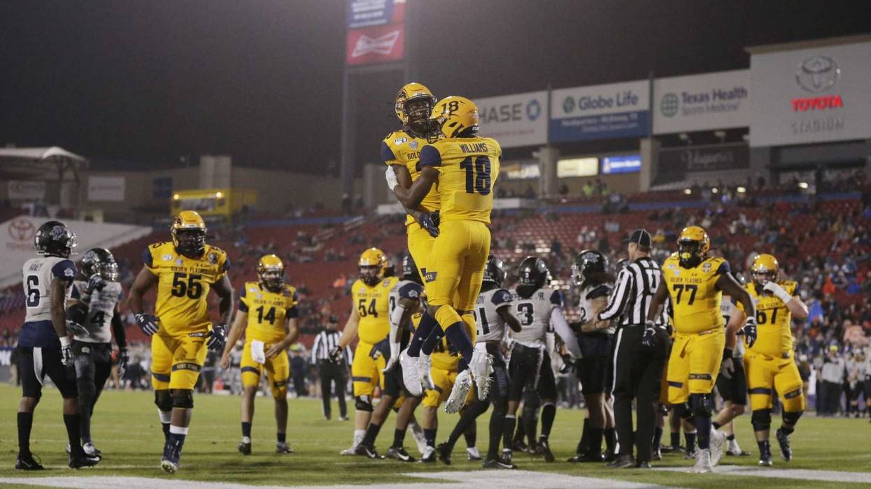 Kent State Golden Flashes running back Xavier Williams (18) and wide receiver Isaiah McKoy (23) celebrate a toouchdown in the first quarter against the Utah State Aggies during the Frisco Bowl at Toyota Stadium.