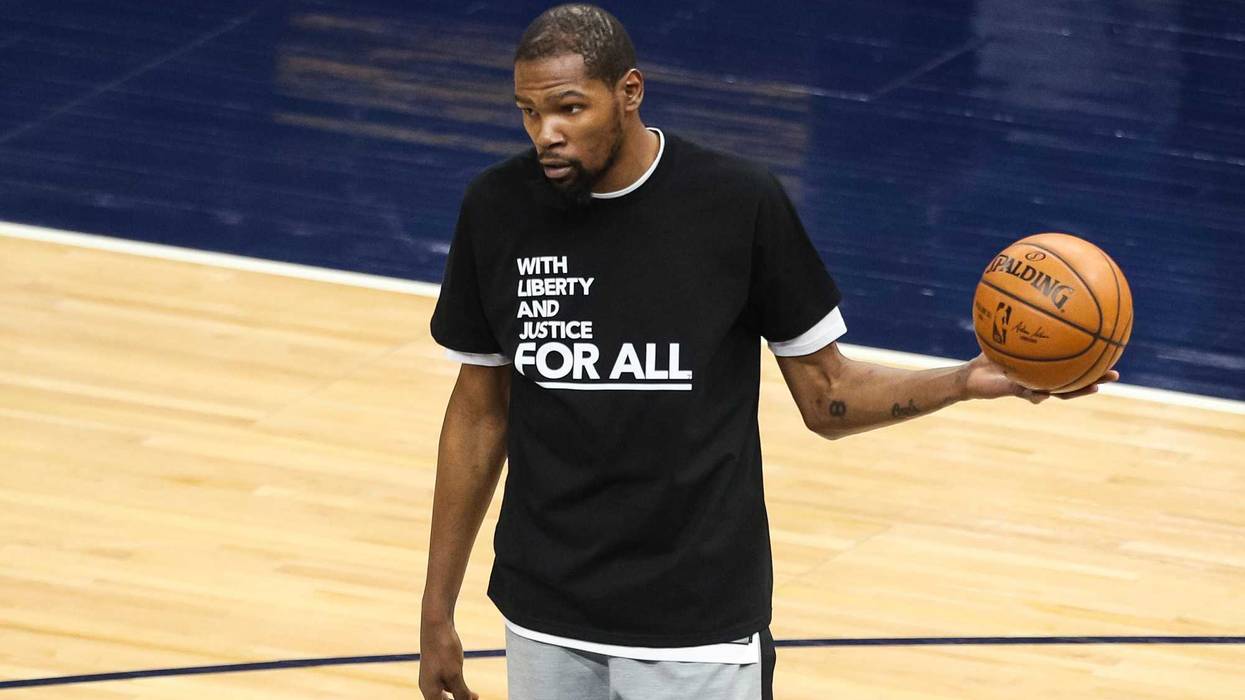 Kevin Durant #7 of the Brooklyn Nets wears a shirt supporting social justice before the start of a game against the Minnesota Timberwolves at Target Center on April 13, 2021 in Minneapolis, Minnesota. Protests continue across the U.S. after 20-year-old Daunte Wright was recently killed by a Brooklyn Center, Minnesota police officer during a traffic stop. NOTE TO USER: User expressly acknowledges and agrees that, by downloading and or using this Photograph, user is consenting to the terms and conditions of the Getty Images License Agreement.