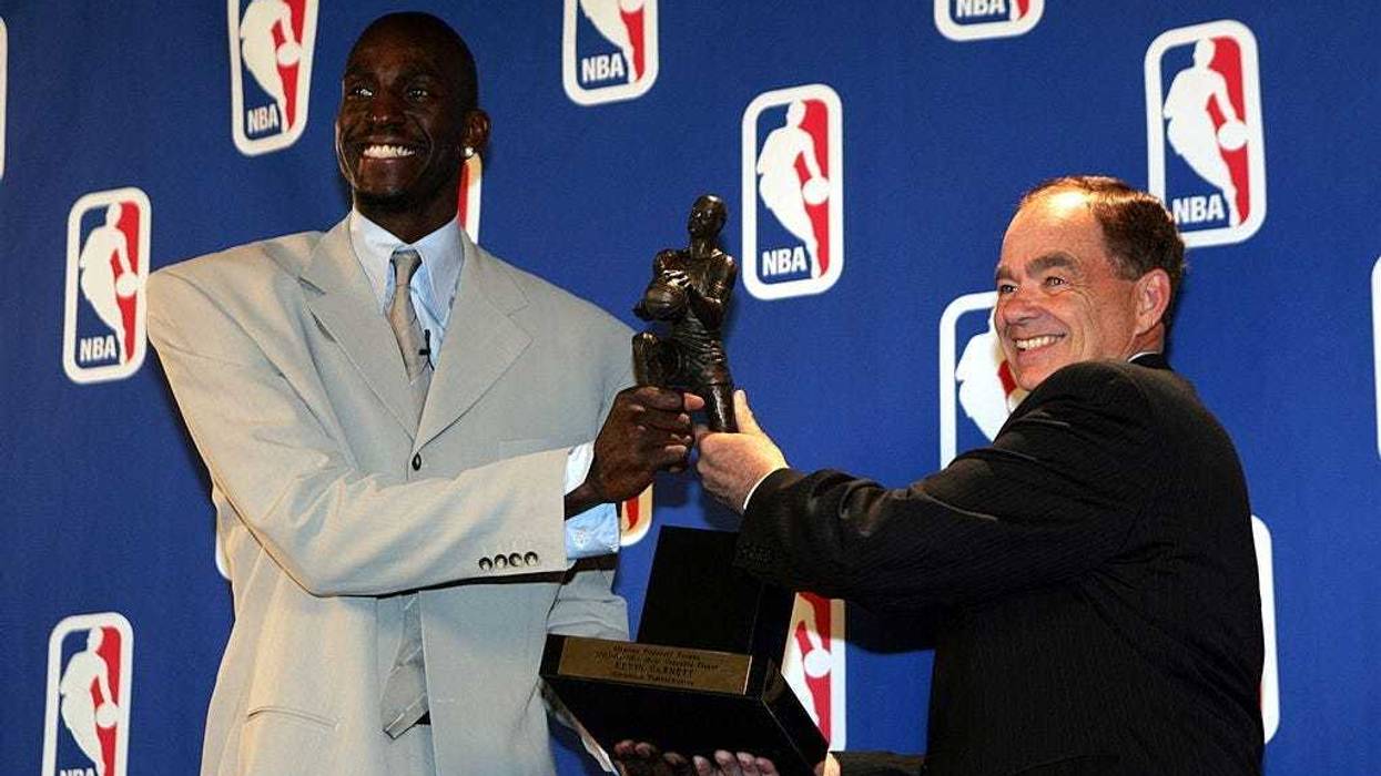 Kevin Garnett #21 of the Minnesota Timberwolves receives the NBA MVP award from Glen Taylor,owner of the Timberwolves on May 3, 2004 at the Target Center in Minneapolis, Minnesota.