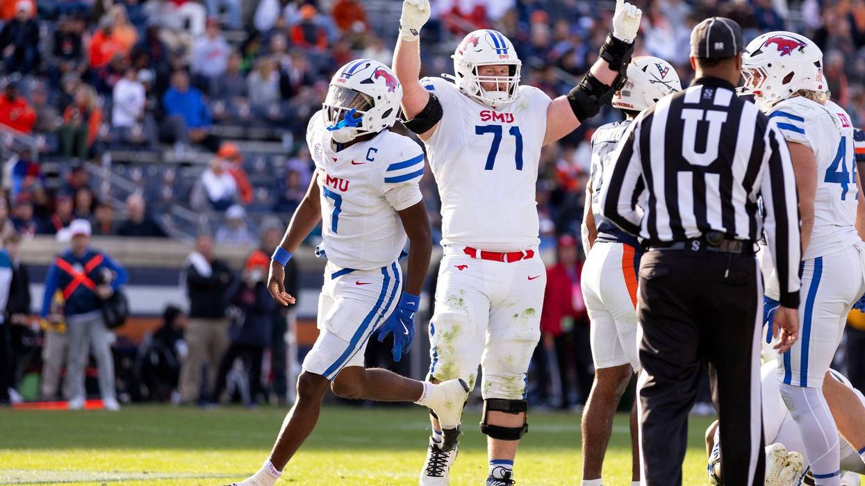 Kevin Jennings #7 and Logan Parr #71 of the Southern Methodist Mustangs celebrate a touchdown in the second half during a game against the Virginia Cavaliers at Scott Stadium on Nov. 23, 2024, in Charlottesville, Virginia.