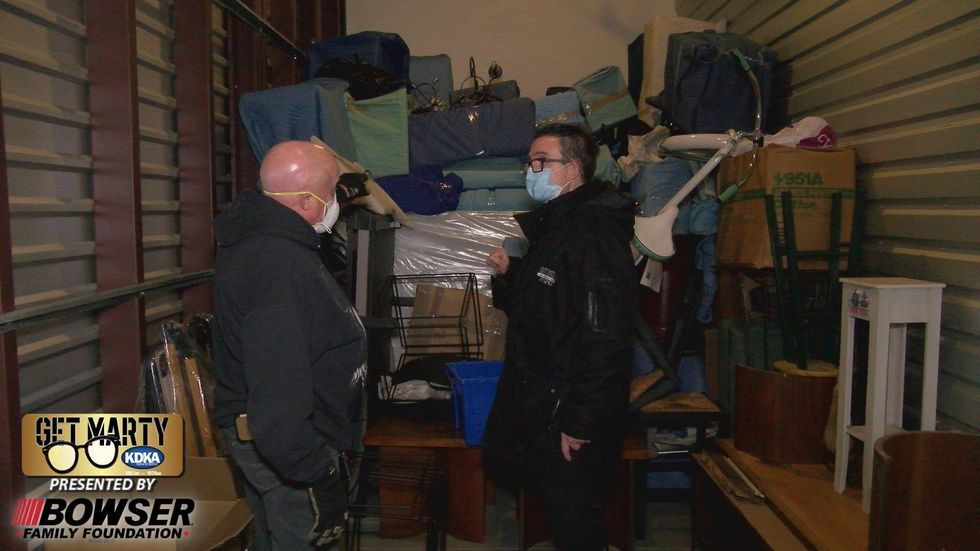 Kevin Seger and Marty Griffin inside storage unit