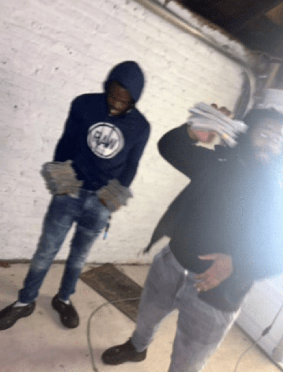 Kevin Williams and Byron Wilson holding stacks of cash gained from selling goods stolen at Westchester Square shopping plaza in Hartsdale on Dec. 16.