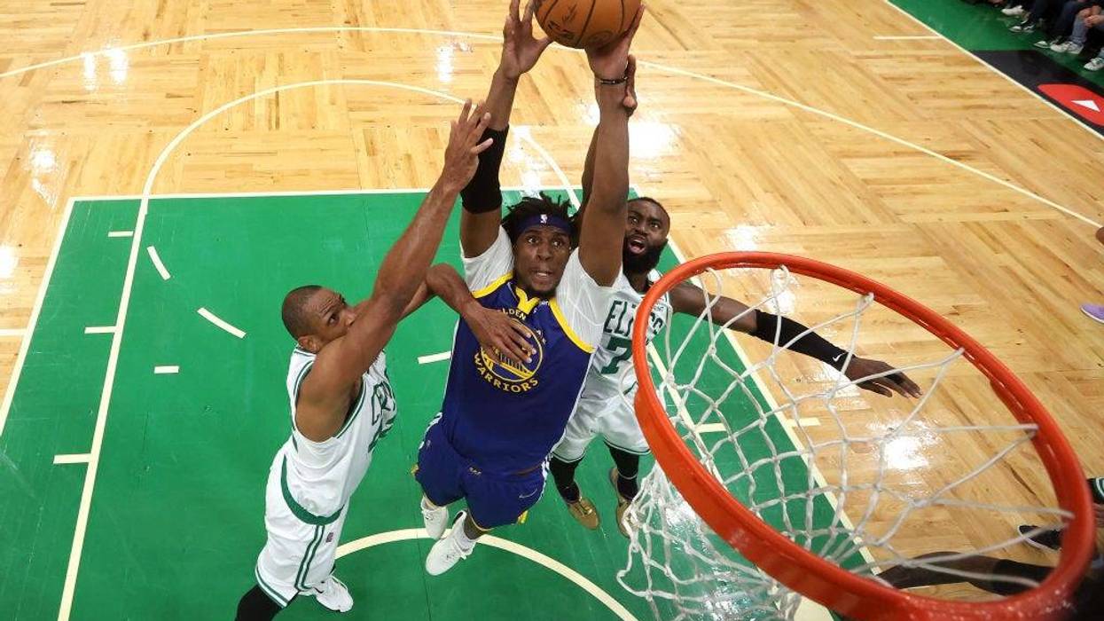 Kevon Looney #5 of the Golden State Warriors battles with Al Horford #42 and Jaylen Brown #7 of the Boston Celtics for a rebound in Game Six of the 2022 NBA Finals at TD Garden on June 16, 2022 in Boston, Massachusetts