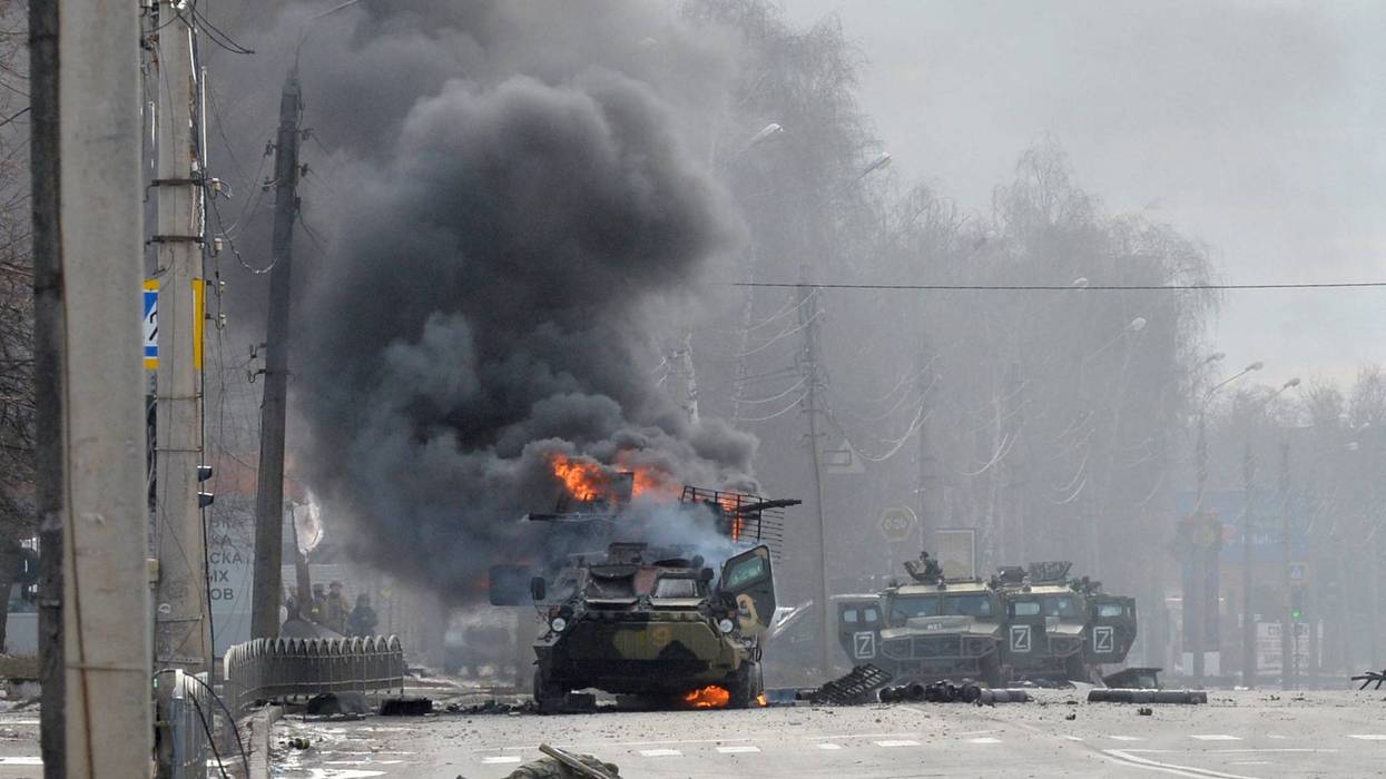 KHARKIV, UKRAINE - FEBRUARY 27: A Russian Armoured personnel carrier (APC) burning during fight with the Ukrainian armed forces in Kharkiv.