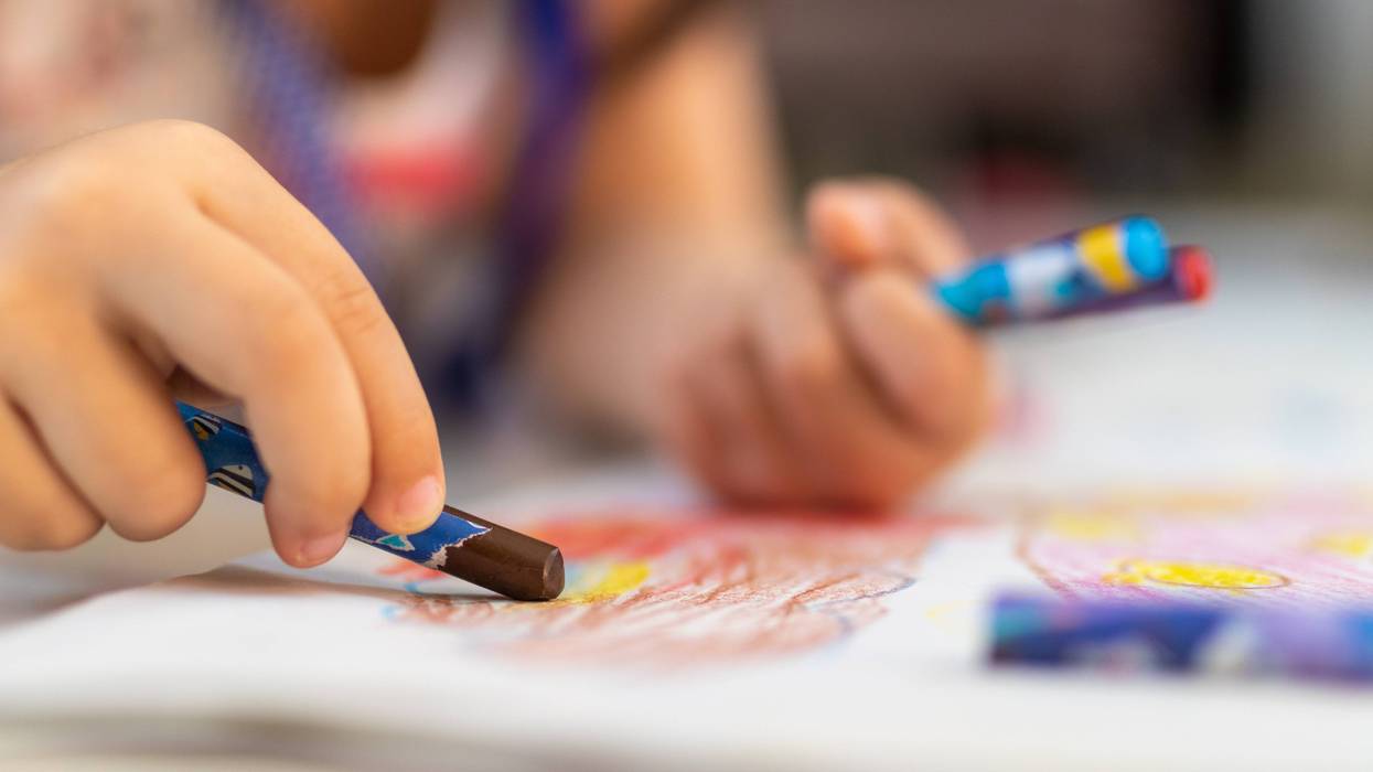 Kid coloring with crayon