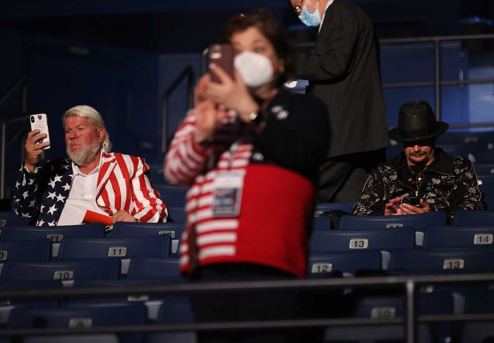Kid Rock (R) and John Daly take their seats without wearing masks, prior to being asked to wear them, at the final presidential debate between U.S. President Donald Trump and Democratic presidential nominee Joe Biden at Belmont University on October 22, 2020 in Nashville, Tennessee. This is the last debate between the two candidates before the election on November 3.