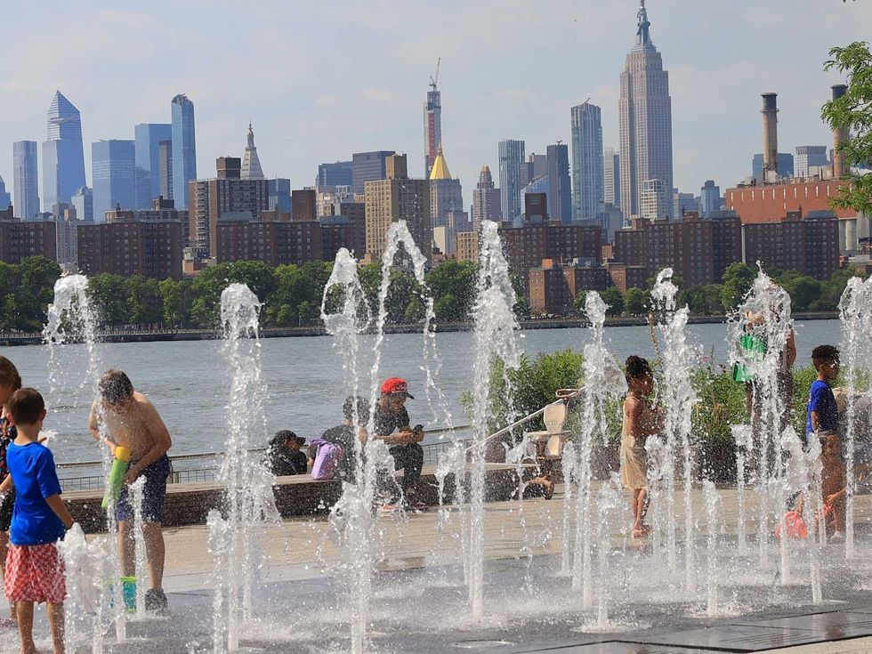 Kids enjoy cool spraying water during a hot weather week on Monday, June 17, in Brooklyn.