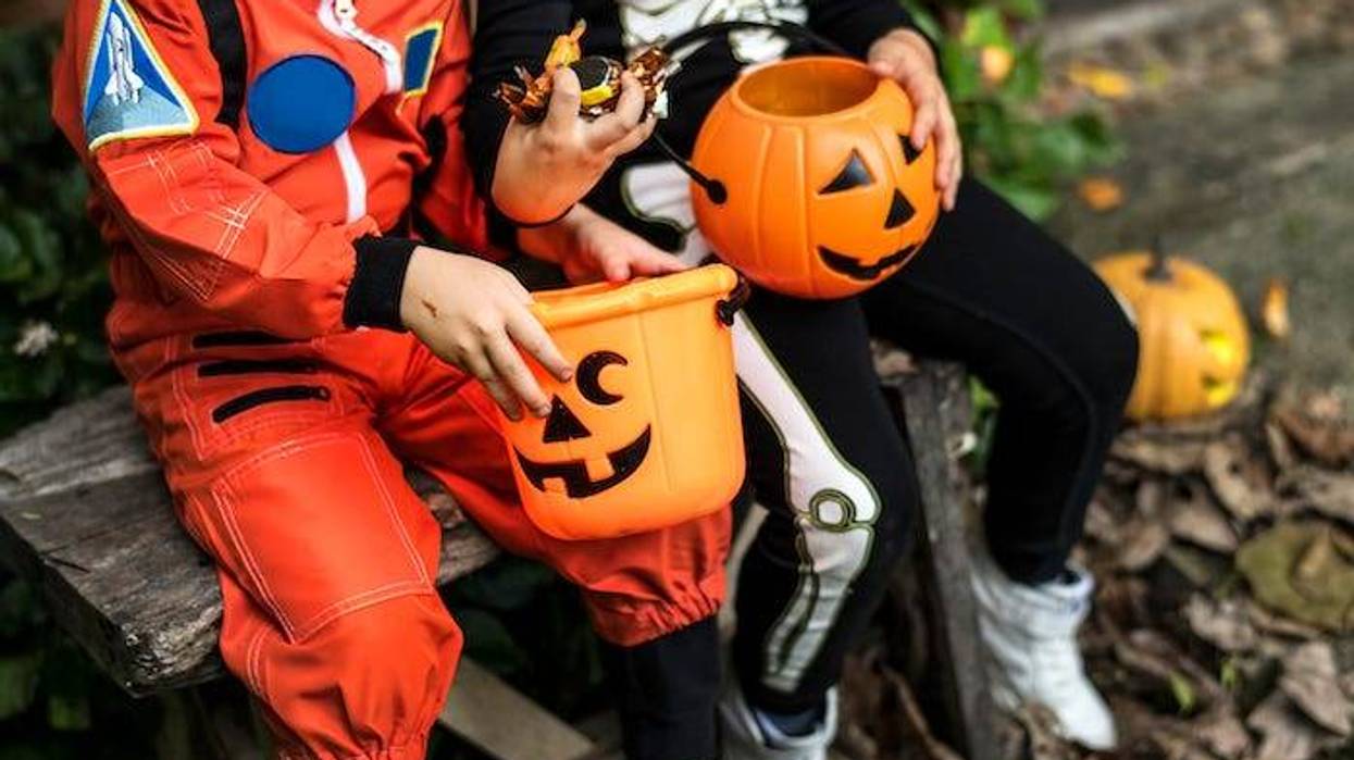 Kids holding Halloween buckets
