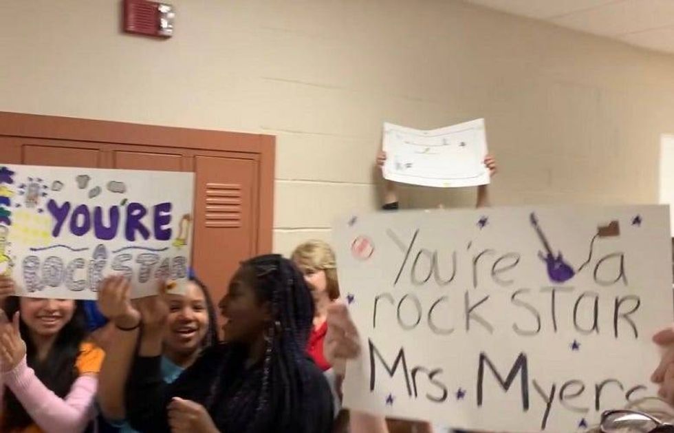 Kids holding up signs