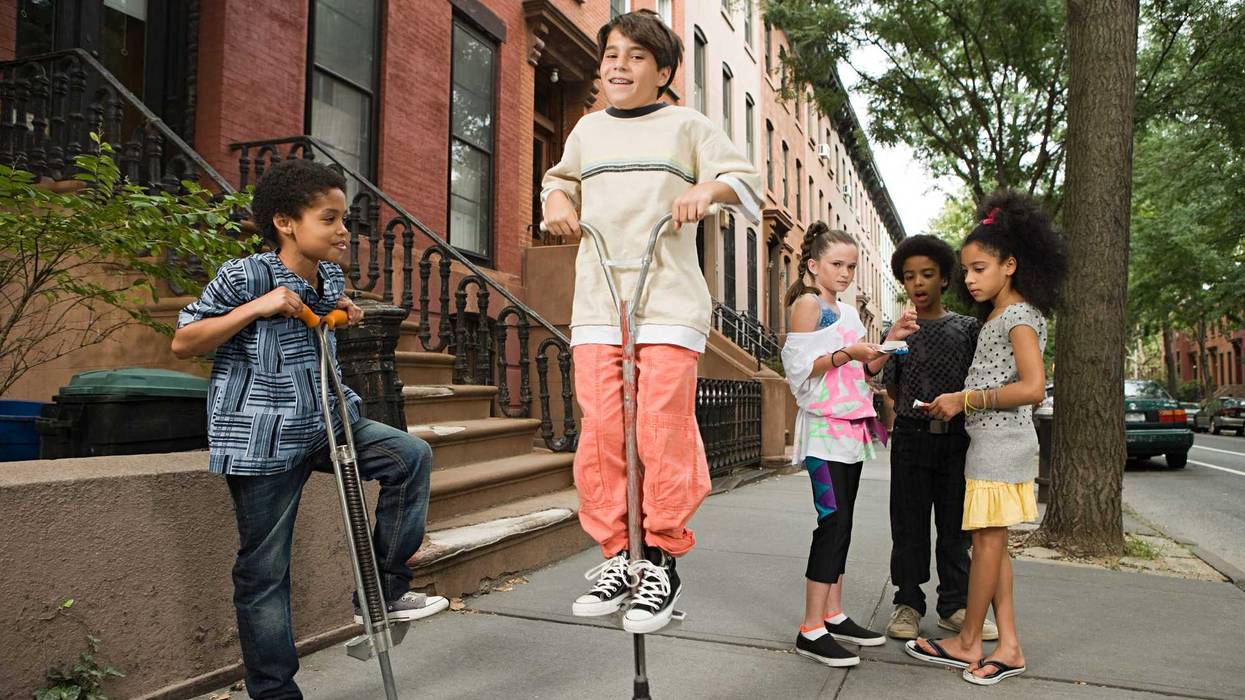 Kids jumping on pogo sticks.