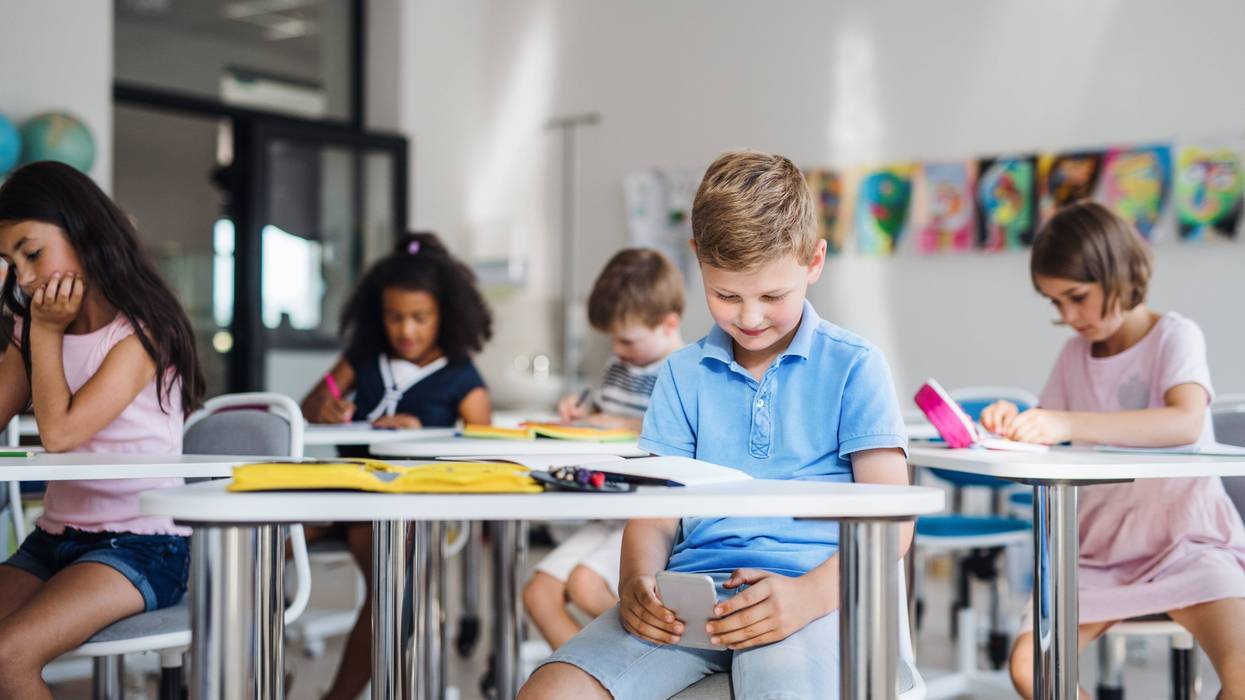 kids on phones in a classroom