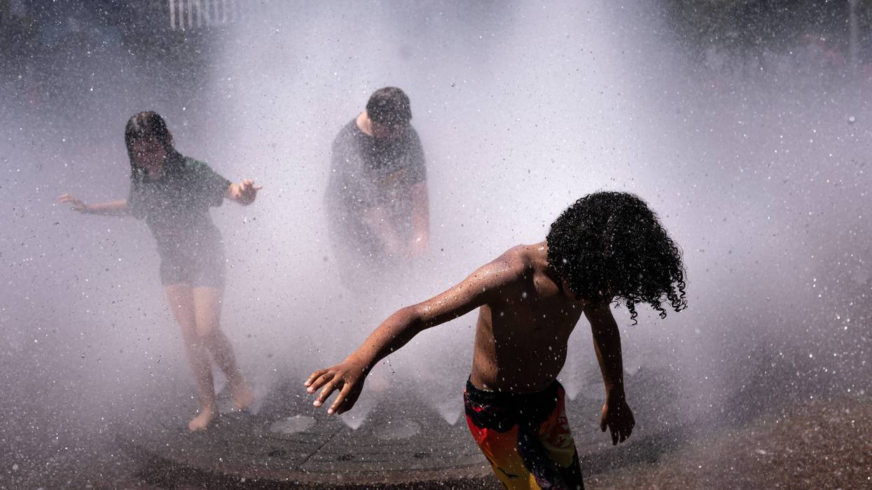 Kids play in the Salmon Springs Fountain in Portland amid a heat wave.